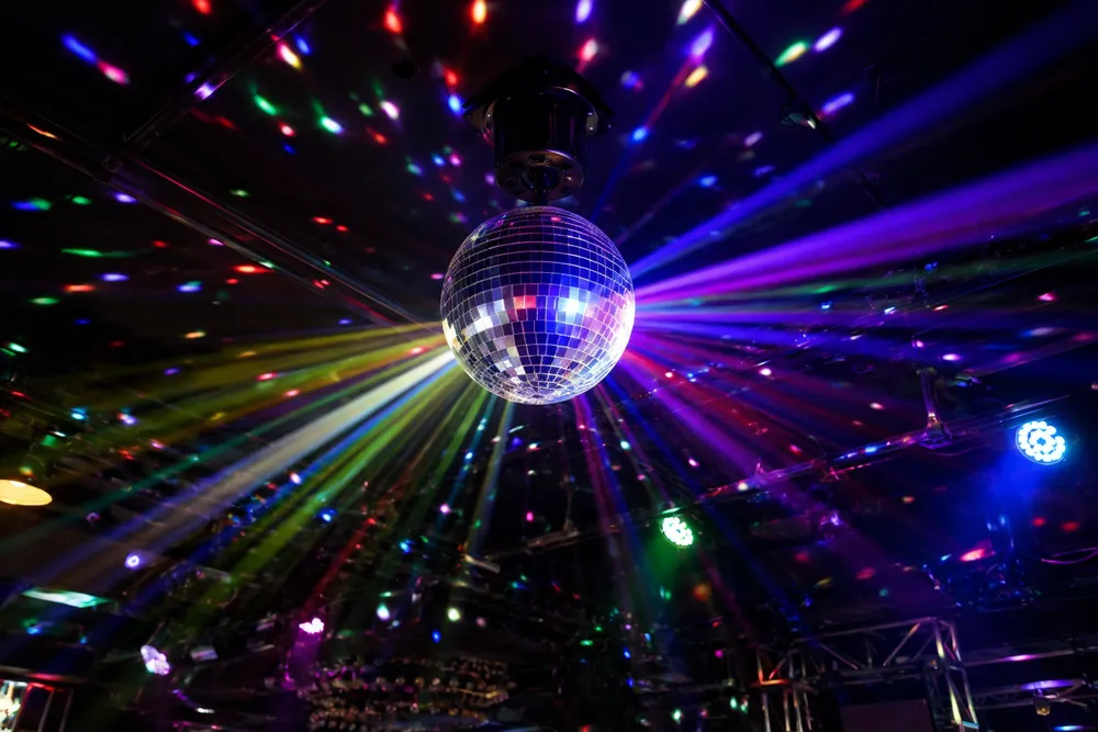 Vefey disco ball light fixture projecting multi-color beams across a dark venue ceiling