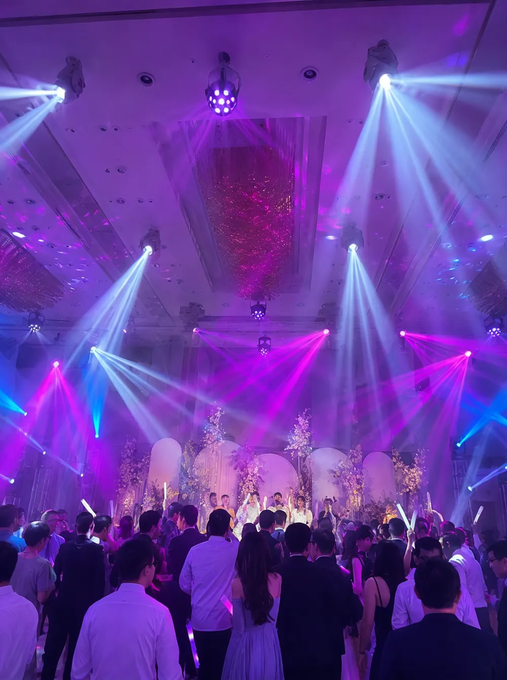 Dance stage lighting fixtures producing high-energy beams and color wash effects on a dance floor